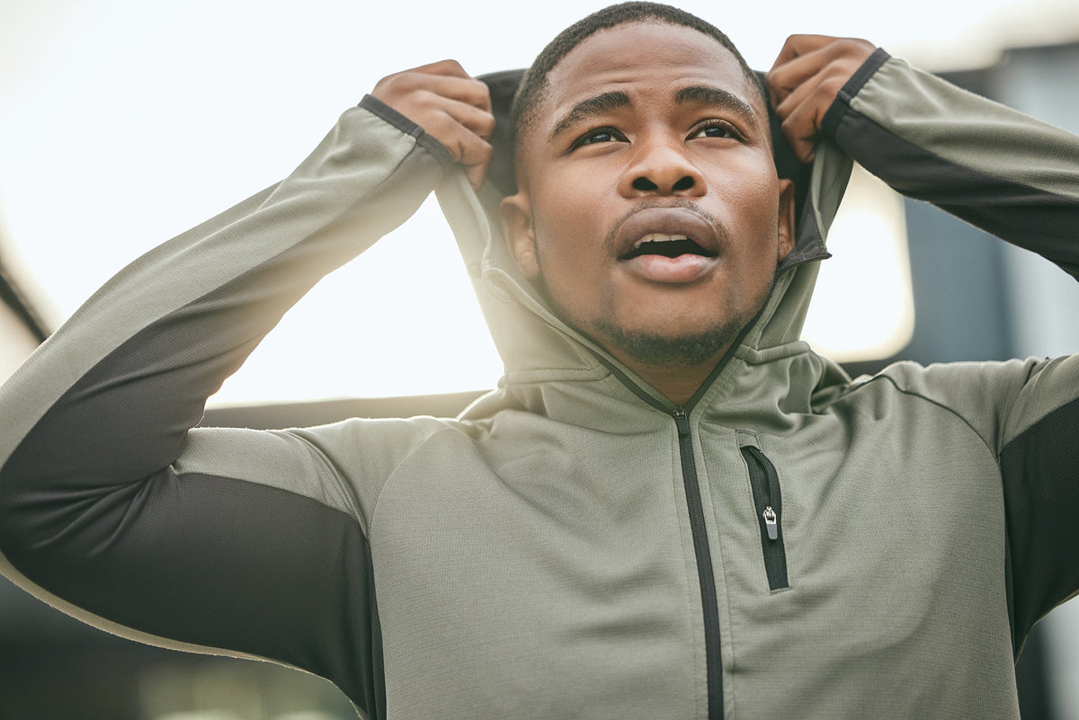 young-man-adjusting-hoodie-in-urban-setting-2026-03-25-05-05-54-utc.jpg